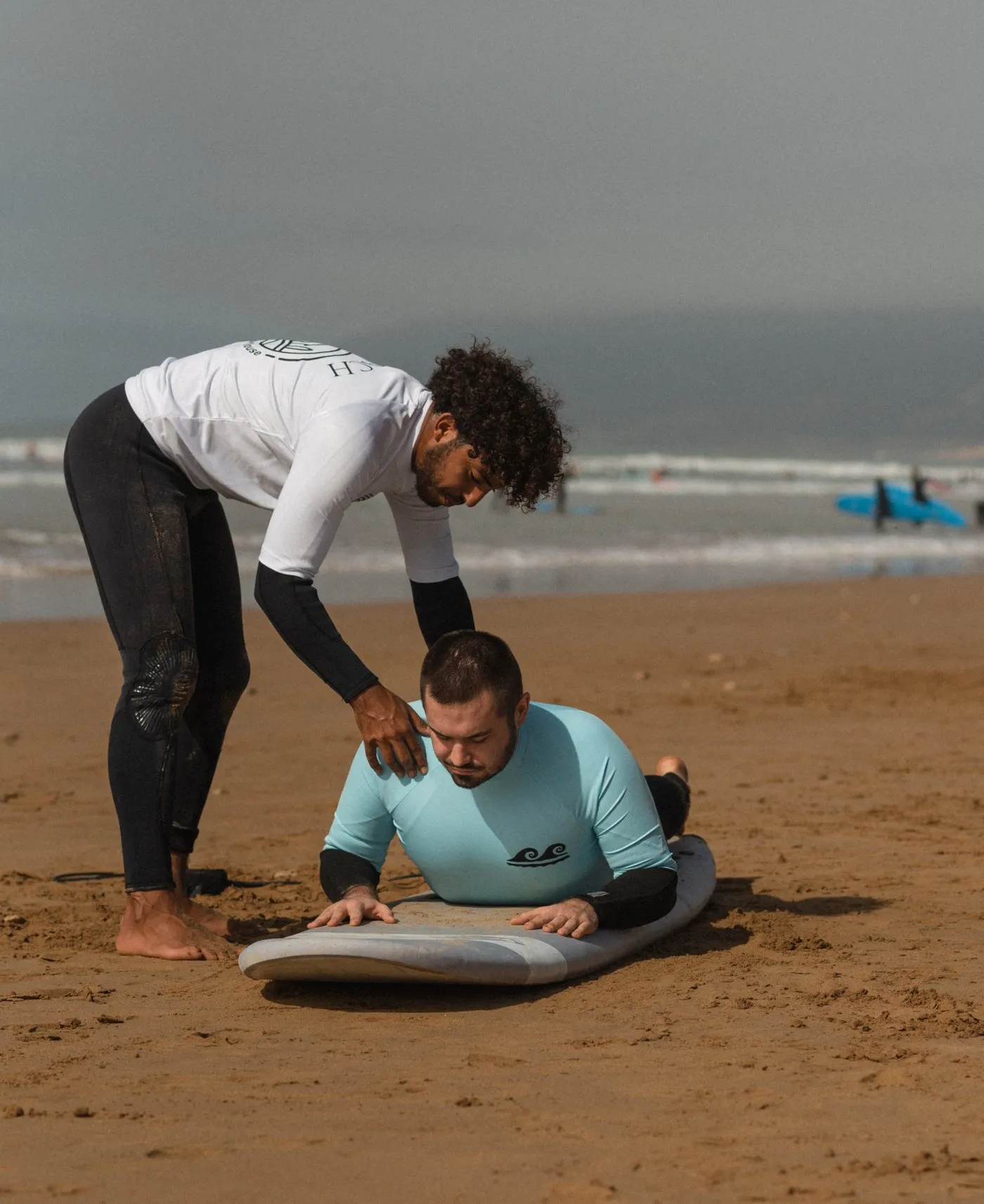 Surf instructor coaching on the beach Taghazout
