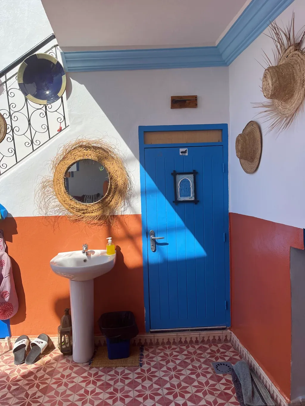 Colorful entrance with blue door and straw decorations